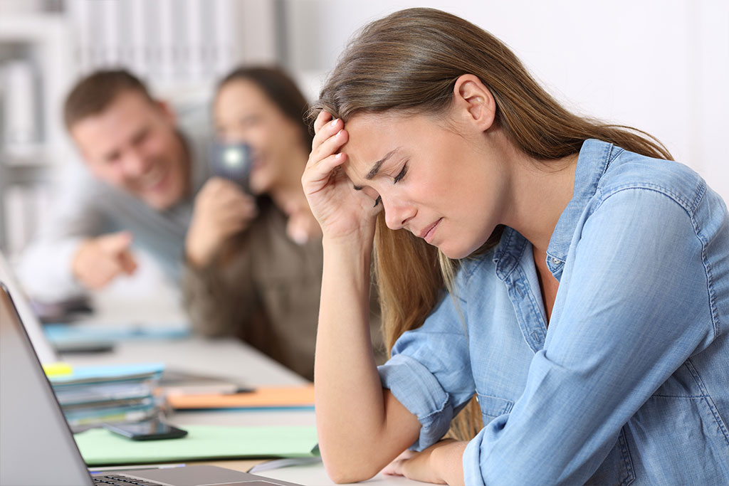 Cyber bullying victim being photographed at office