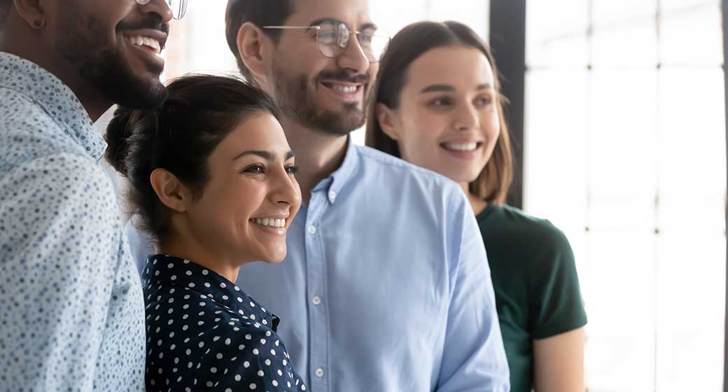 Millennial workers of different races celebrating accomplished project